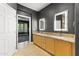 The bathroom offers double sinks with a granite countertop and a view into the bedroom at 15928 W Zinnia Ct, Surprise, AZ 85374
