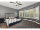 This bedroom features a spacious layout, a large window with shutters, and a ceiling fan for added comfort at 15928 W Zinnia Ct, Surprise, AZ 85374