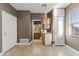 Bedroom with an attached bathroom, built in storage, kitchenette, and tile floors at 15928 W Zinnia Ct, Surprise, AZ 85374