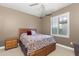 This bedroom features a wood bed frame, a side table, and a window providing natural light at 15928 W Zinnia Ct, Surprise, AZ 85374