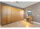 Bedroom featuring built-in wardrobe, neutral walls, and a window with blinds at 15928 W Zinnia Ct, Surprise, AZ 85374