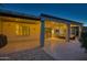 Back of the home with covered patio, stone flooring, and outdoor seating at 15928 W Zinnia Ct, Surprise, AZ 85374