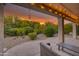 A partially covered patio with outdoor seating and view of the desert landscaping at 15928 W Zinnia Ct, Surprise, AZ 85374