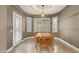 Dining area boasts a wooden table set, natural lighting and light brown walls at 15928 W Zinnia Ct, Surprise, AZ 85374
