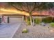 A single story home with a 3 car garage and desert landscaping at 15928 W Zinnia Ct, Surprise, AZ 85374