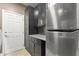 The kitchen offers stainless steel appliances and dark cabinets with granite countertops and a stylish backsplash at 15928 W Zinnia Ct, Surprise, AZ 85374