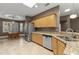 Kitchen with granite countertops, stainless steel appliances, and ample counter space overlooking the dining area at 15928 W Zinnia Ct, Surprise, AZ 85374