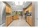 Bright kitchen featuring wood cabinets, tile flooring, stainless steel appliances and backyard views at 15928 W Zinnia Ct, Surprise, AZ 85374