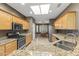 Well-equipped kitchen with granite countertops, stainless steel appliances, and warm wood cabinetry at 15928 W Zinnia Ct, Surprise, AZ 85374