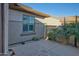 Side yard featuring desert landscaping, a concrete patio, and a private entrance at 15928 W Zinnia Ct, Surprise, AZ 85374