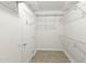 The walk-in closet offers ample storage space with metal shelving and neutral tile flooring at 15928 W Zinnia Ct, Surprise, AZ 85374