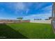 Expansive grass backyard enclosed with block wall, offering space for customization at 16004 W Honeysuckle Dr, Surprise, AZ 85387