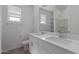Bright bathroom with double vanity, large mirror, and ample lighting at 16004 W Honeysuckle Dr, Surprise, AZ 85387