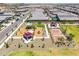 Aerial view of community park features a playground, covered picnic areas and a pickleball court for recreation at 16004 W Honeysuckle Dr, Surprise, AZ 85387