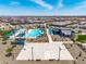 An aerial view of the community pool and basketball court featuring covered seating and a splash pad for children at 16004 W Honeysuckle Dr, Surprise, AZ 85387