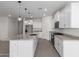 Spacious kitchen with stainless steel appliances, granite countertops, a large island, and bright white cabinets at 16004 W Honeysuckle Dr, Surprise, AZ 85387