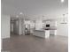 Spacious kitchen area features white cabinets, stainless steel appliances, and an expansive center island at 16004 W Honeysuckle Dr, Surprise, AZ 85387