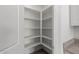 A spacious, walk-in pantry offers ample storage with its numerous shelves and granite countertop nearby at 16004 W Honeysuckle Dr, Surprise, AZ 85387