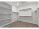 Spacious walk-in closet featuring shelving and hanging rods for ample storage solutions at 16004 W Honeysuckle Dr, Surprise, AZ 85387