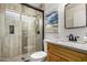 Bright bathroom with wood-look tile shower, toilet, and vanity with granite counter at 16210 W Durango St, Goodyear, AZ 85338