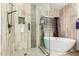 Spa-like bathroom with a luxurious free-standing tub and a frameless glass shower at 16210 W Durango St, Goodyear, AZ 85338