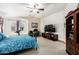 Bright bedroom with blue accents, complemented by a cozy desk and a spacious TV at 16210 W Durango St, Goodyear, AZ 85338
