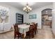 Dining room with a chandelier over a table for eight, a blue accent wall, and a vintage blue hutch at 16210 W Durango St, Goodyear, AZ 85338