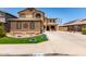 Charming two-story home featuring a landscaped front yard and a long driveway at 16210 W Durango St, Goodyear, AZ 85338