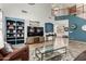 Open-concept living room with tall ceilings, wood floors, and stairs to the second floor at 16210 W Durango St, Goodyear, AZ 85338