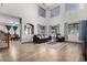 Bright living room with high ceilings, wood floors, large windows, and comfortable seating area at 16210 W Durango St, Goodyear, AZ 85338