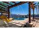 Backyard pool with a water feature, seating under pergola and desert landscaping offers relaxing outdoor living at 16210 W Durango St, Goodyear, AZ 85338
