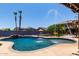 Backyard pool with water feature, desert landscaping and shaded patio ideal for entertaining and relaxation at 16210 W Durango St, Goodyear, AZ 85338