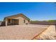 Spacious backyard and patio area with rock landscaping at 17345 W Spur Dr, Surprise, AZ 85387