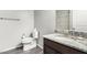 This bathroom features a granite countertop, updated fixtures, and wood look floors at 17345 W Spur Dr, Surprise, AZ 85387