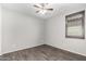 Bedroom with dark wood-look floors, and window with shutters at 17345 W Spur Dr, Surprise, AZ 85387