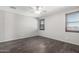 Bedroom with wood-look floors, ceiling fan, and shuttered windows at 17345 W Spur Dr, Surprise, AZ 85387