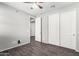 Bedroom featuring wood-look floors, ceiling fan, and double closets at 17345 W Spur Dr, Surprise, AZ 85387