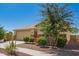 A well-maintained single-story home with a two car garage and mature landscaping at 17345 W Spur Dr, Surprise, AZ 85387