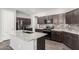 Modern kitchen with granite countertops, stainless steel appliances, and a functional center island at 17345 W Spur Dr, Surprise, AZ 85387
