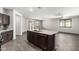 Open-concept kitchen featuring granite countertops, stainless steel appliances, and seamless integration to the living area at 17345 W Spur Dr, Surprise, AZ 85387
