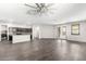 Bright and airy living room featuring wood-style flooring, neutral paint, and a contemporary ceiling fan at 17345 W Spur Dr, Surprise, AZ 85387