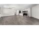 Spacious open-concept living area with wood-style floors, seamlessly flowing into the modern kitchen at 17345 W Spur Dr, Surprise, AZ 85387