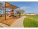 Community playground with green grass, canopy, and walkway at 17345 W Spur Dr, Surprise, AZ 85387