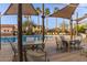 Community pool area with shaded seating, tables, and chairs at 17345 W Spur Dr, Surprise, AZ 85387