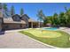 Expansive backyard with a well-manicured putting green, and sparkling pool at 1750 E Mallory St, Mesa, AZ 85203