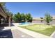 Relaxing backyard space with a sparkling pool and a charming putting green at 1750 E Mallory St, Mesa, AZ 85203