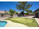 Private backyard features a verdant putting green and sparkling blue pool at 1750 E Mallory St, Mesa, AZ 85203