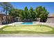 Lush backyard offering a private pool and a custom putting green at 1750 E Mallory St, Mesa, AZ 85203