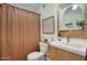 Well-lit bathroom featuring a modern vanity, stylish mirror, and shower with curtain at 1750 E Mallory St, Mesa, AZ 85203
