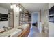 Contemporary bathroom with double sink vanity, wood shelves, and open doorway to the bedroom at 1750 E Mallory St, Mesa, AZ 85203